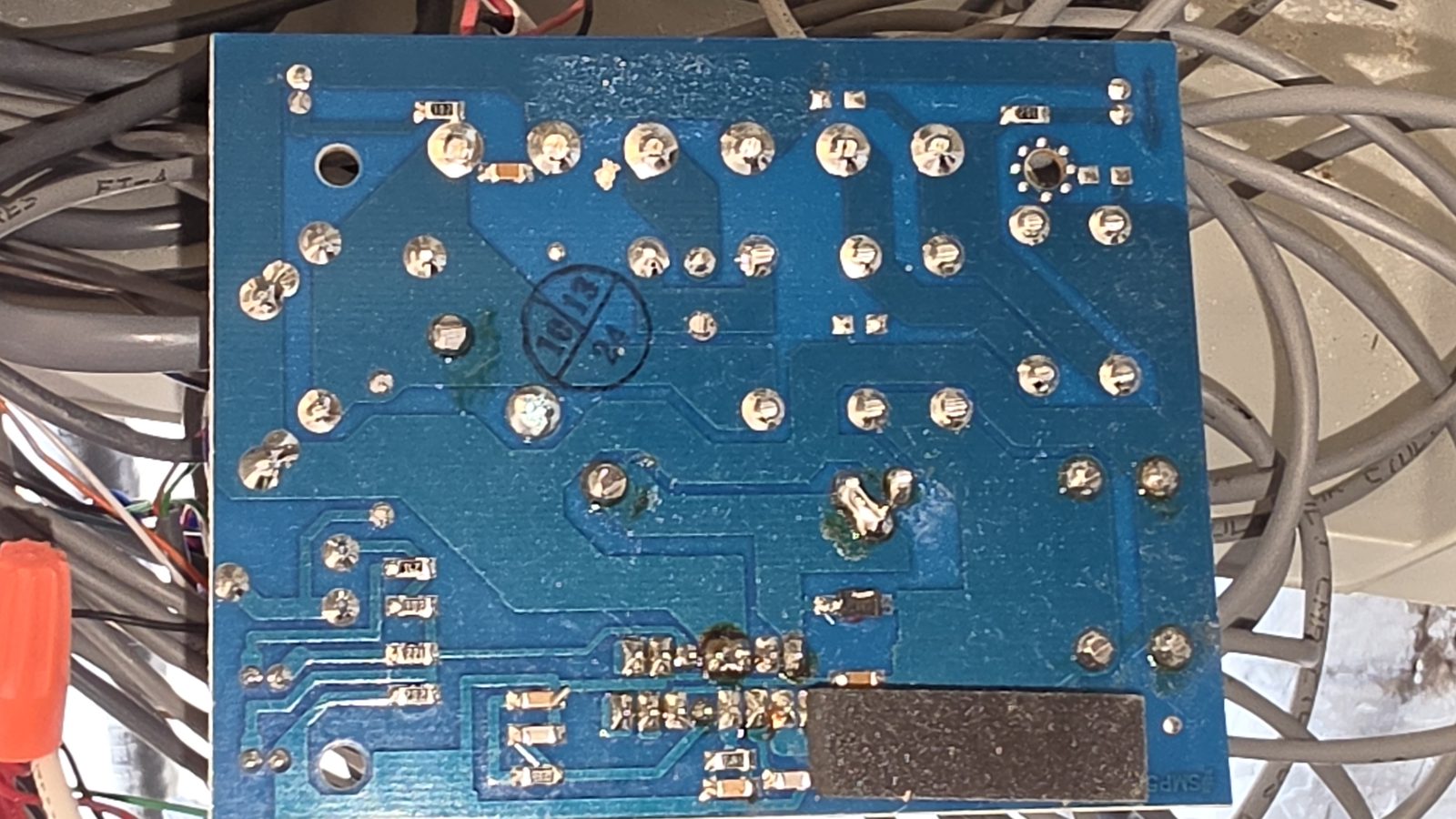 The underside of a control board — tracing which traces are still live.