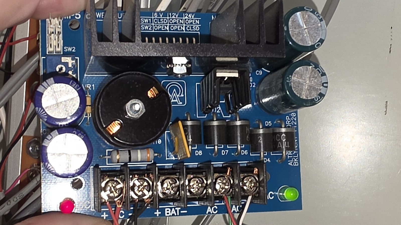 The RBK-5 relay board, hand-labeled by a previous tech: “BAD, replace this.” The entire maintenance history of the system.